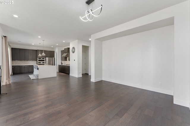 15875 NW Ridgeline St, Portland, OR 97229 - unfurnished living room with dark wood-style flooring and recessed lighting