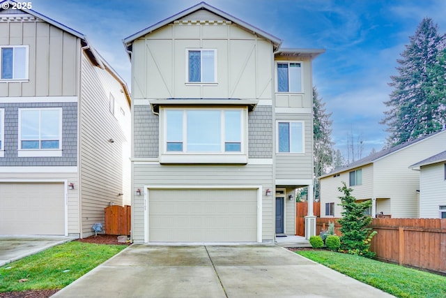 view of front of property featuring driveway, a garage, and fence