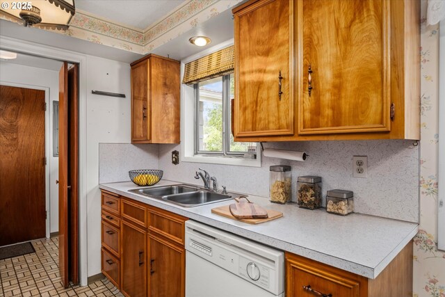 82091 Lost Valley Ln, Dexter, OR 97431 - kitchen featuring dishwasher, light countertops, a sink, and brown cabinets