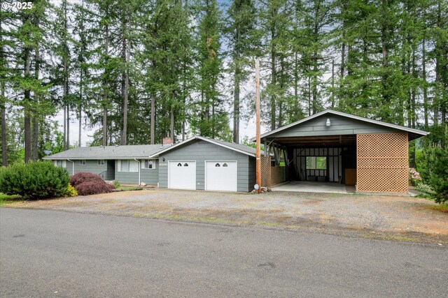 82091 Lost Valley Ln, Dexter, OR 97431 - view of front of home with asphalt driveway and view of wooded area