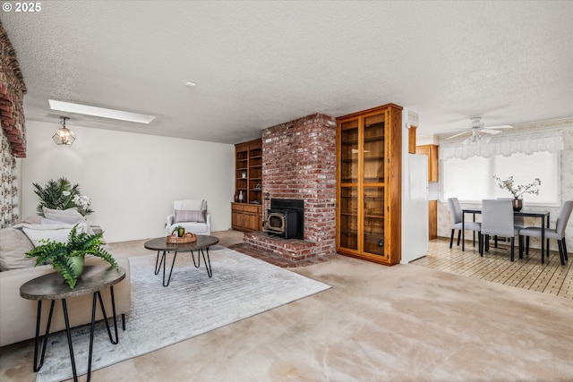 82091 Lost Valley Ln, Dexter, OR 97431 - living area with a wood stove, a textured ceiling, carpet, and ceiling fan
