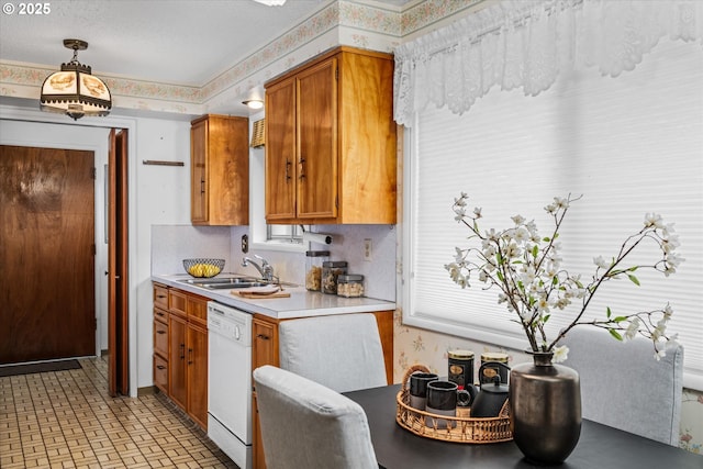 82091 Lost Valley Ln, Dexter, OR 97431 - kitchen featuring dishwasher, wallpapered walls, light countertops, brown cabinetry, and a sink
