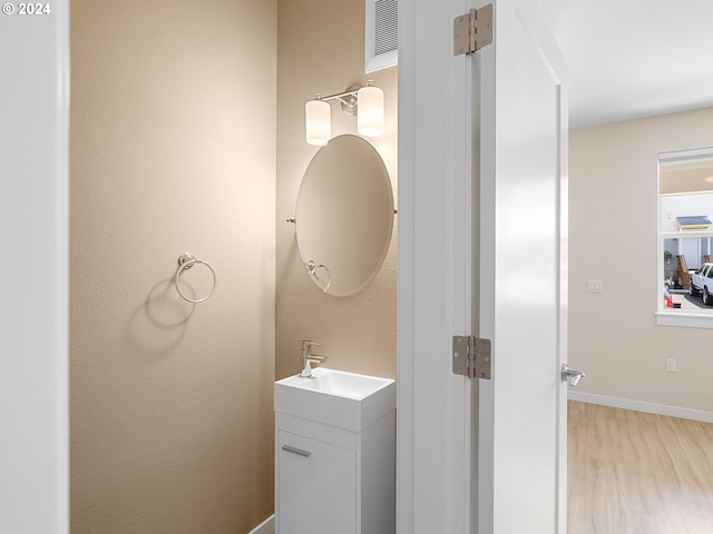 bathroom with vanity and hardwood / wood-style floors