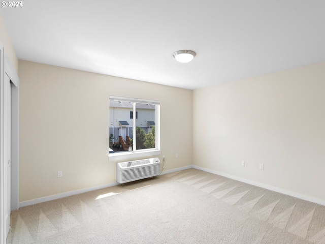 spare room featuring carpet and a wall unit AC