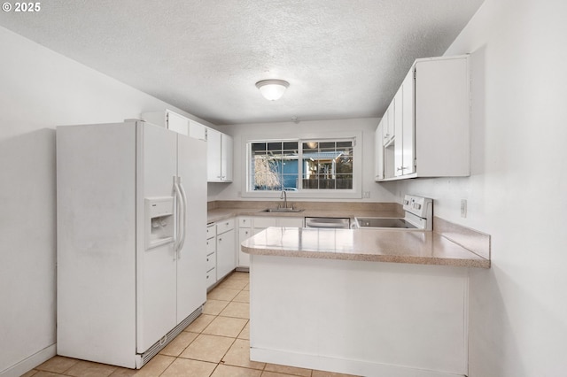 kitchen with white fridge with ice dispenser, stove, a sink, and white cabinets