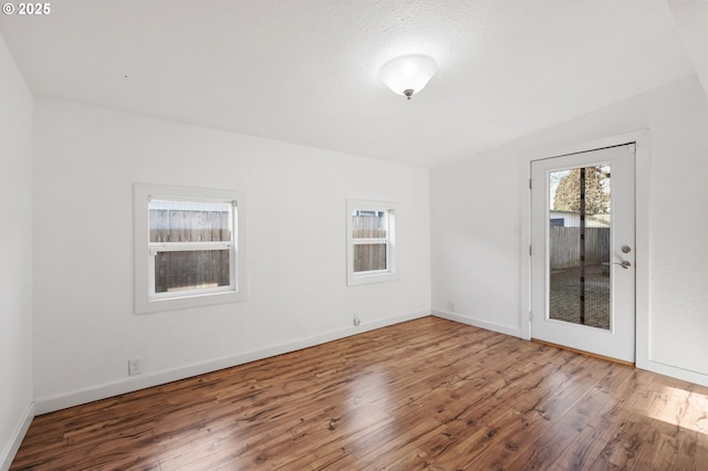 empty room with wood finished floors and baseboards