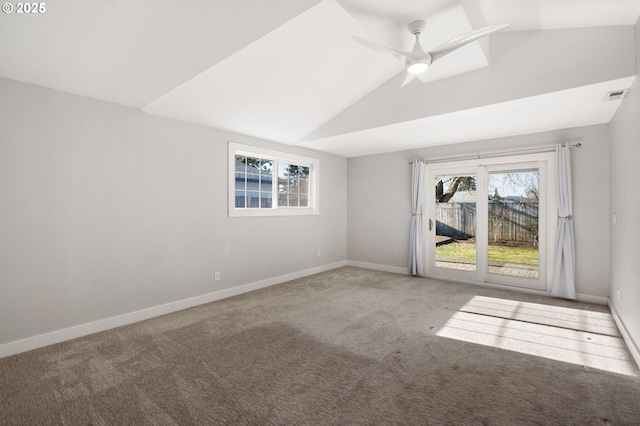 empty room featuring carpet, visible vents, a ceiling fan, vaulted ceiling, and baseboards