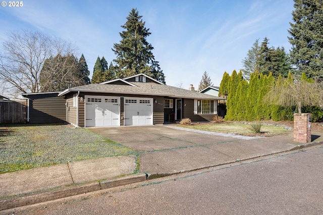 ranch-style house featuring a garage, a front yard, driveway, and a chimney