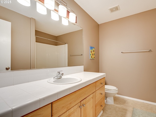 1091 56th St, Washougal, WA 98671 - bathroom featuring toilet, vanity, a shower, and baseboards