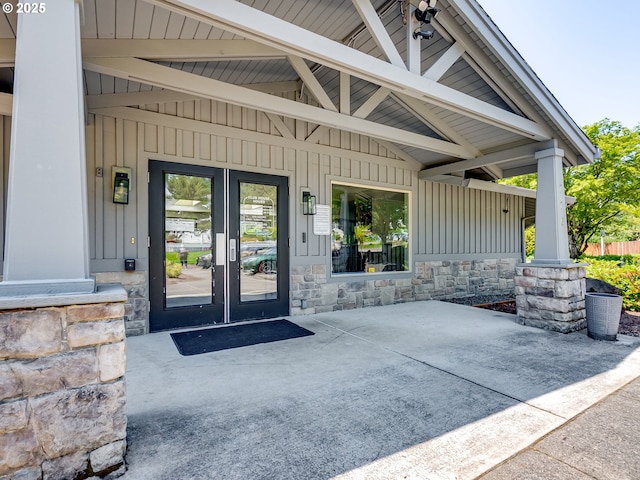 1091 56th St, Washougal, WA 98671 - doorway to property featuring board and batten siding, stone siding, french doors, and a patio