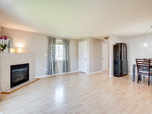 1091 56th St, Washougal, WA 98671 - unfurnished living room with light wood-style flooring, baseboards, and a premium fireplace