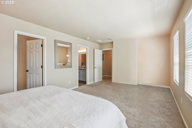 503 NW Hertel St, Hillsboro, OR 97124 - carpeted bedroom with multiple windows, baseboards, and ensuite bath