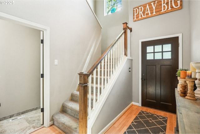 503 NW Hertel St, Hillsboro, OR 97124 - foyer entrance featuring stairway, a towering ceiling, light wood-style floors, and baseboards