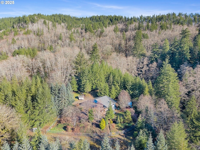 birds eye view of property with a forest view