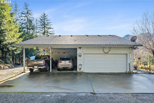 garage featuring driveway and a carport