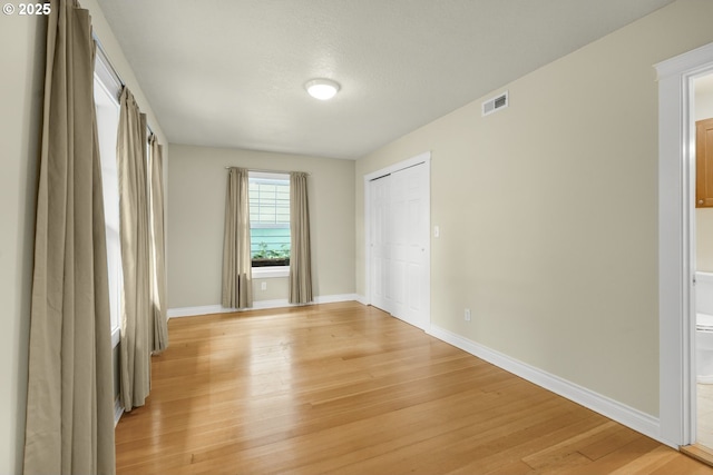 7307 SW Capitol Hwy, Portland, OR 97219 - unfurnished bedroom with light wood-style flooring, a closet, and ensuite bath