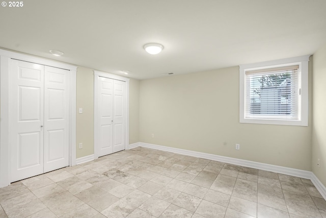 7307 SW Capitol Hwy, Portland, OR 97219 - unfurnished bedroom with multiple closets and baseboards