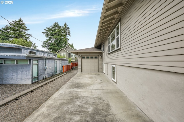 7307 SW Capitol Hwy, Portland, OR 97219 - view of side of home with concrete driveway and a garage