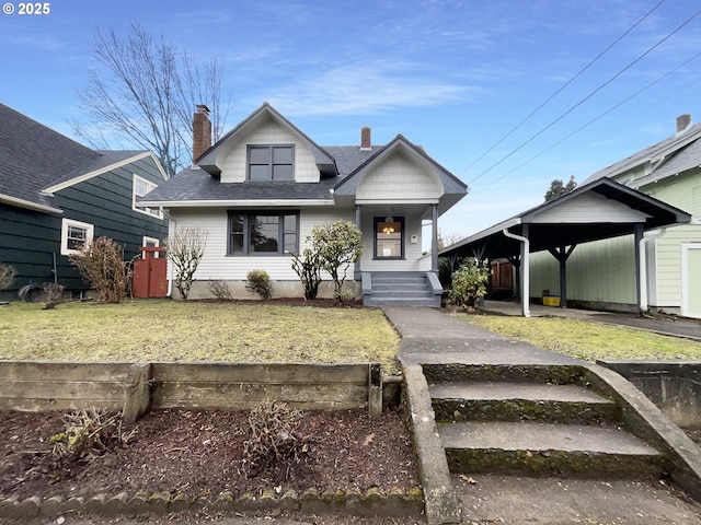 view of front of home featuring a carport and a front lawn