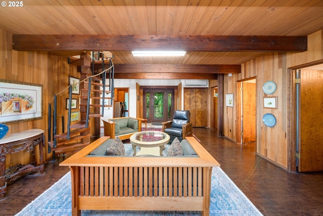 living room with beam ceiling, a wall unit AC, wooden ceiling, and wooden walls