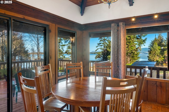 dining area with a water view and hardwood / wood-style floors