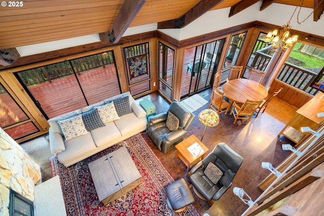 living room with vaulted ceiling with beams and a notable chandelier