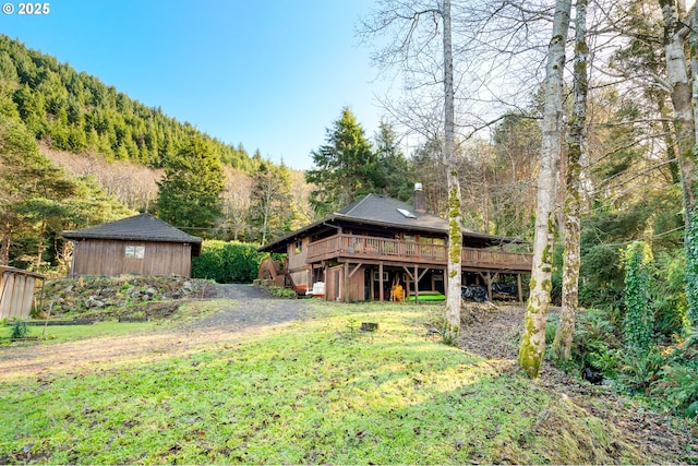 view of yard with a deck with mountain view