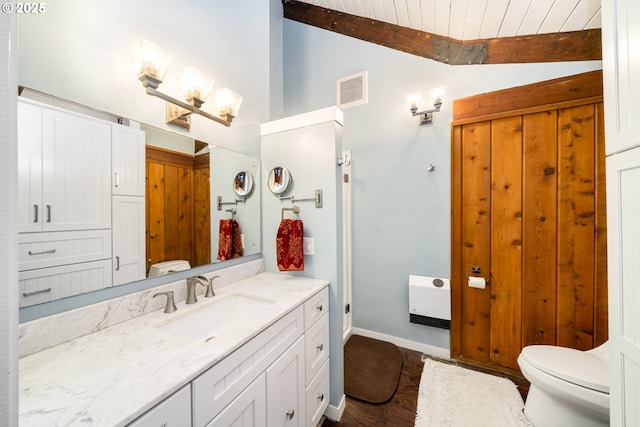 bathroom with wood ceiling, vanity, toilet, and vaulted ceiling with beams