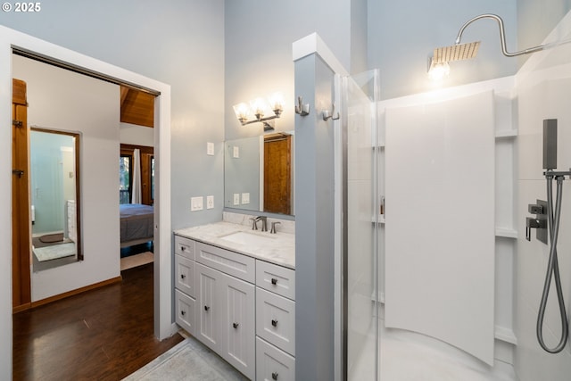 bathroom featuring an enclosed shower, vanity, and hardwood / wood-style flooring