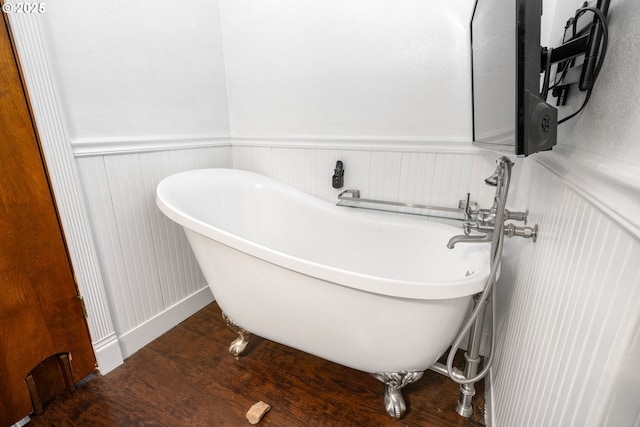 bathroom featuring hardwood / wood-style flooring and a washtub