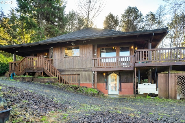 back of property with a wooden deck