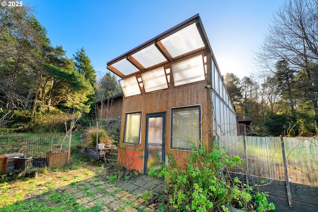 view of side of home featuring an outdoor structure