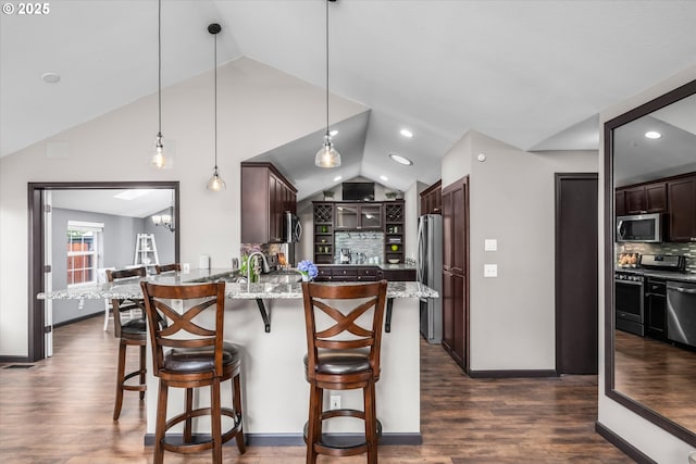 870 Sheraton Dr, Eugene, OR 97401 - kitchen featuring appliances with stainless steel finishes, lofted ceiling, a peninsula, backsplash, and dark brown cabinetry