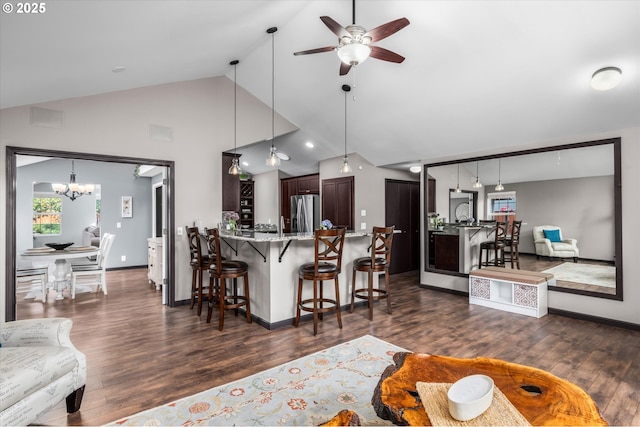 870 Sheraton Dr, Eugene, OR 97401 - kitchen with stainless steel fridge with ice dispenser, a ceiling fan, dark wood-type flooring, a breakfast bar area, and high vaulted ceiling