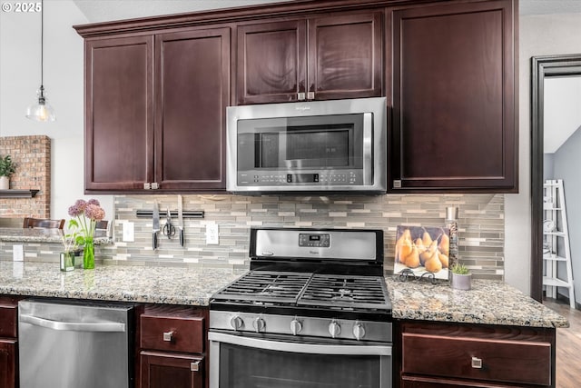 870 Sheraton Dr, Eugene, OR 97401 - kitchen with appliances with stainless steel finishes, decorative backsplash, and light stone counters