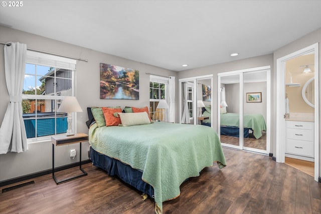 870 Sheraton Dr, Eugene, OR 97401 - bedroom with two closets, wood finished floors, multiple windows, and recessed lighting