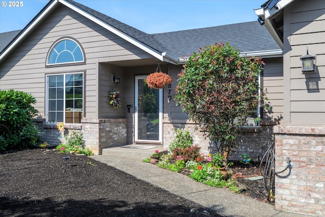 870 Sheraton Dr, Eugene, OR 97401 - doorway to property featuring a shingled roof and brick siding