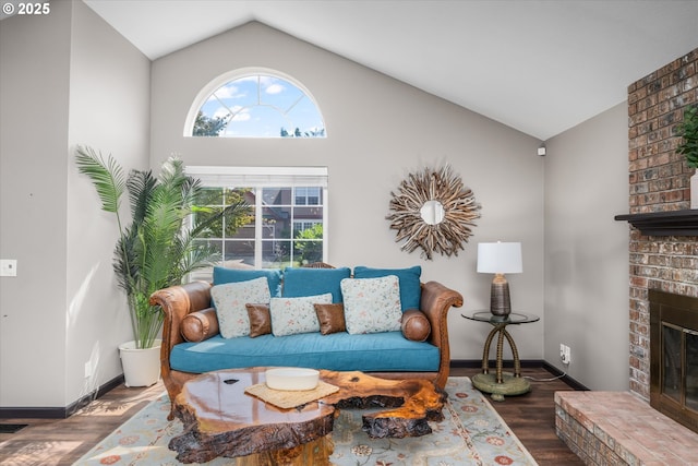 870 Sheraton Dr, Eugene, OR 97401 - living room featuring vaulted ceiling, a fireplace, and wood finished floors