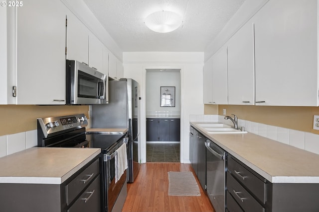 5585 E Evergreen Blvd, Vancouver, WA 98661 - kitchen featuring stainless steel appliances, light countertops, light wood-type flooring, white cabinets, and a textured ceiling