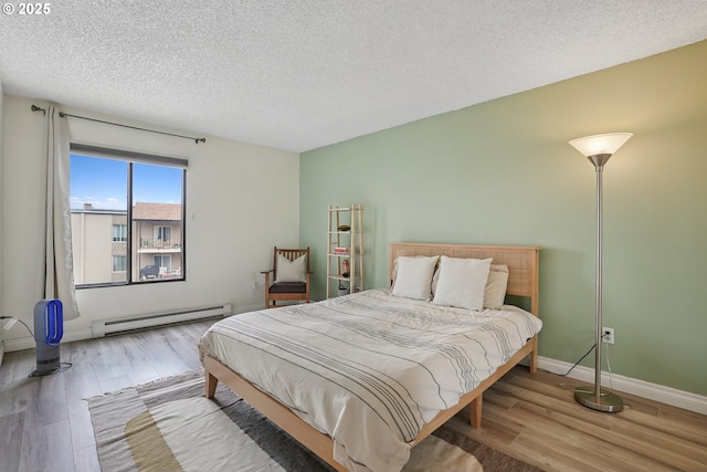 5585 E Evergreen Blvd, Vancouver, WA 98661 - bedroom featuring a baseboard heating unit, wood finished floors, and a textured ceiling