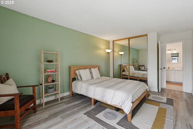 5585 E Evergreen Blvd, Vancouver, WA 98661 - bedroom with wood finished floors, a closet, and ensuite bathroom