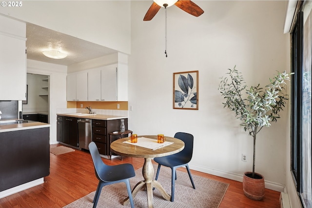 5585 E Evergreen Blvd, Vancouver, WA 98661 - dining room featuring wood finished floors, a ceiling fan, a baseboard radiator, and a towering ceiling