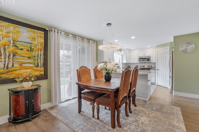 11619 NE 102nd Cir, Vancouver, WA 98662 - dining area featuring baseboards, recessed lighting, wood finished floors, and a chandelier