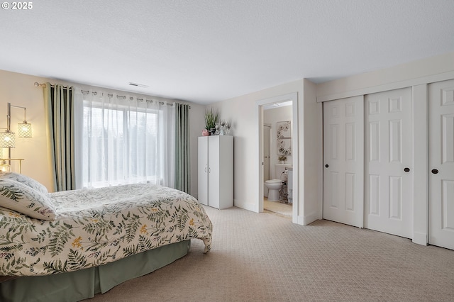 11619 NE 102nd Cir, Vancouver, WA 98662 - bedroom featuring visible vents, a closet, connected bathroom, and light colored carpet