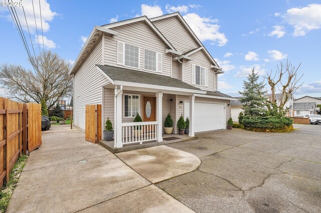 11619 NE 102nd Cir, Vancouver, WA 98662 - traditional-style home with covered porch, fence, driveway, and a garage