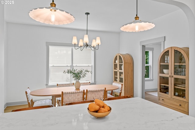 625 NE 69th Ave, Portland, OR 97213 - dining room with a chandelier, baseboards, and wood finished floors