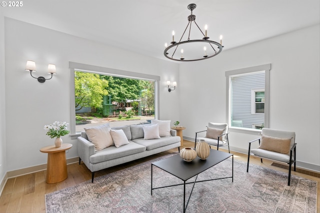 625 NE 69th Ave, Portland, OR 97213 - living area with a chandelier, wood finished floors, and baseboards