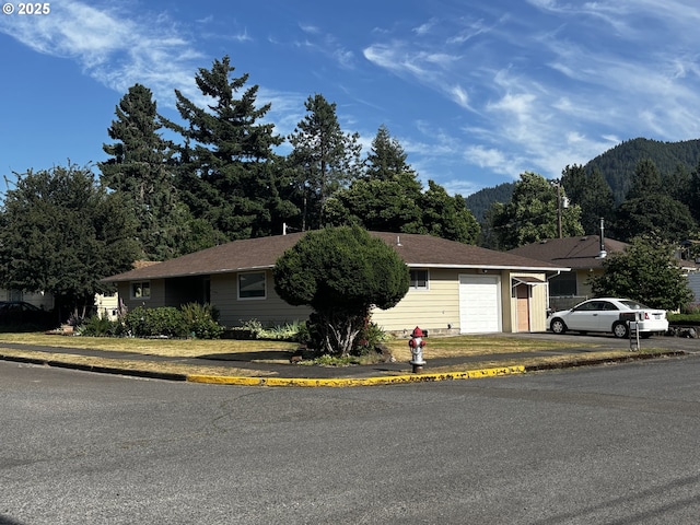 47858 W 1st St, Oakridge, OR 97463 - ranch-style house with an attached garage and a mountain view