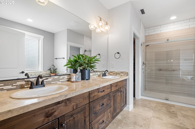 bathroom featuring vanity, an enclosed shower, and backsplash