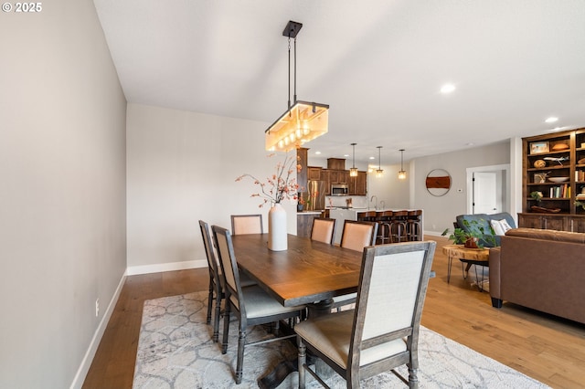 dining area featuring light hardwood / wood-style floors and sink